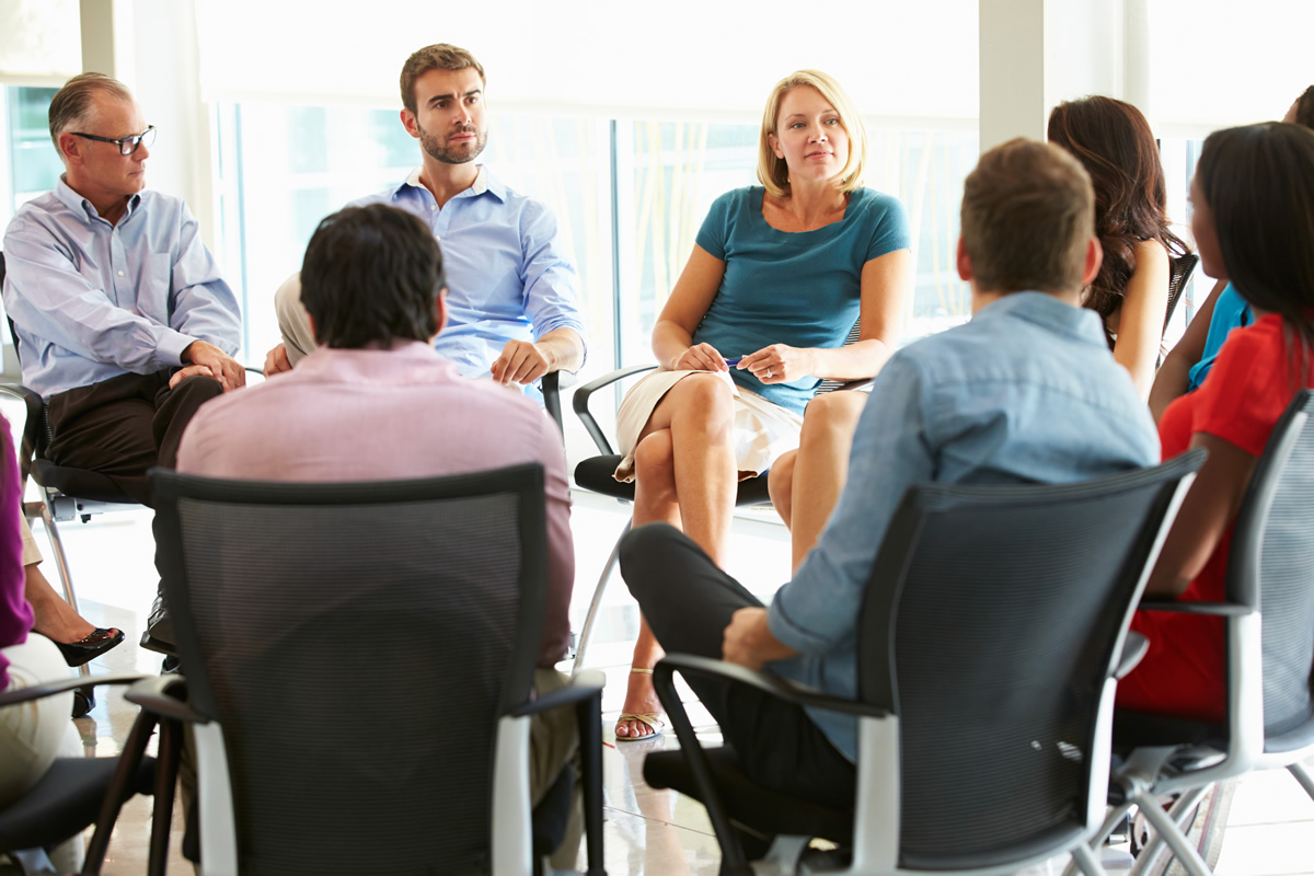 group of people seated in business meeting